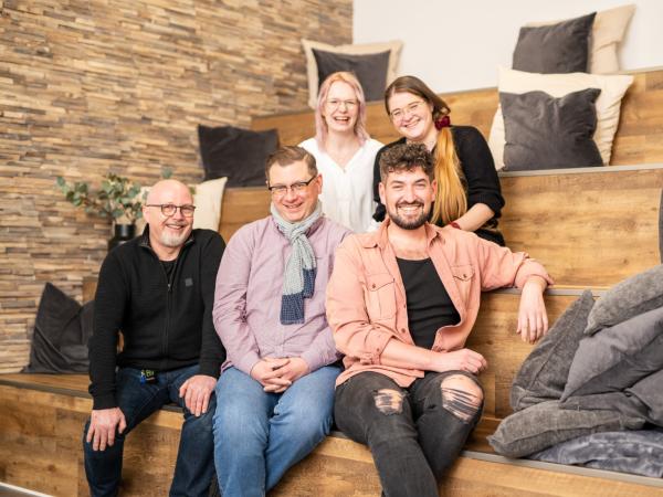 5 Mitarbeitende auf Treppe